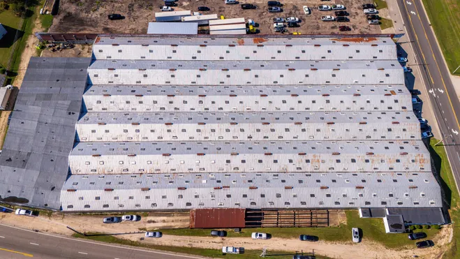 Aerial view of a large commercial building with a metal roof