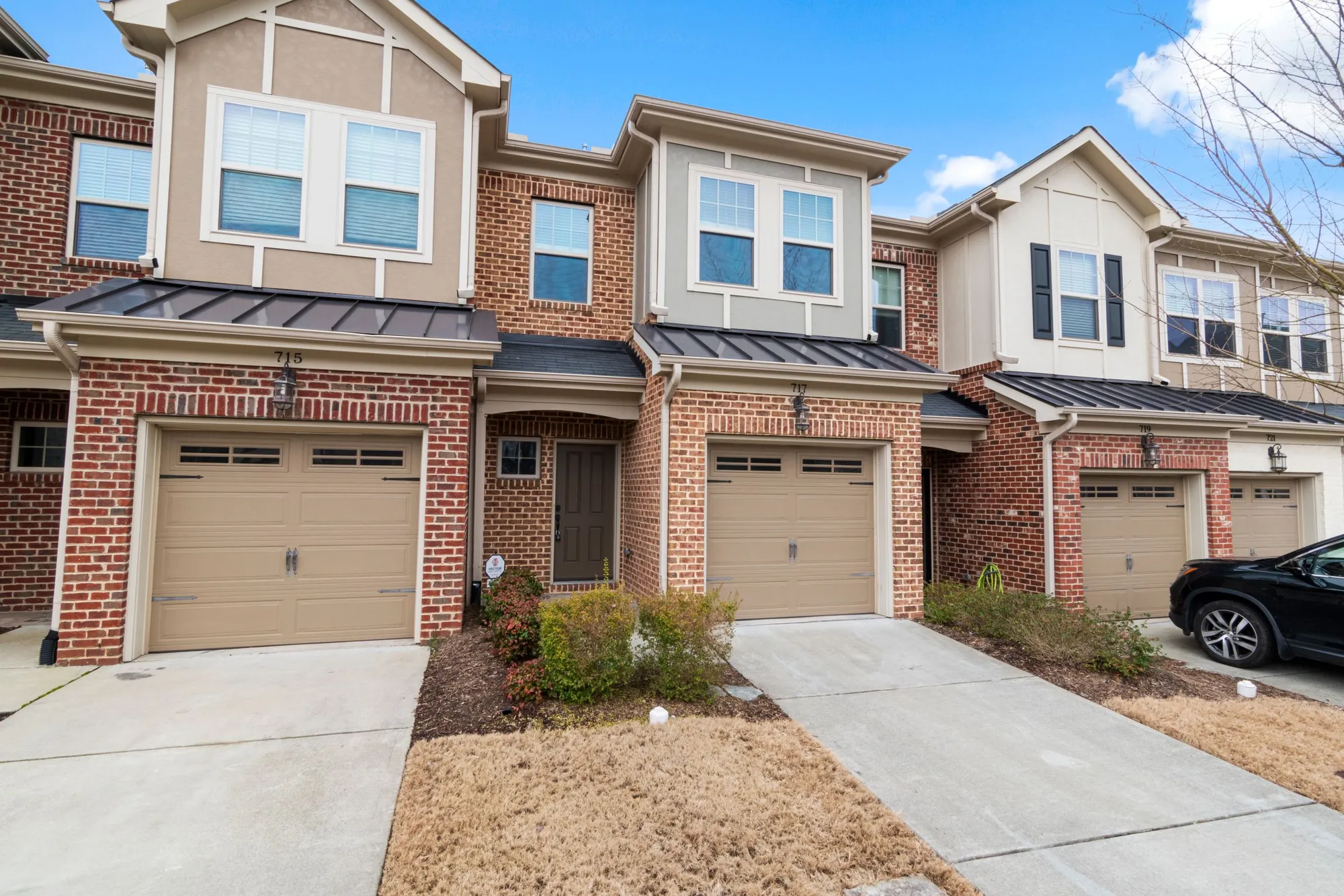 Row of attached brick townhomes with matching rooflines